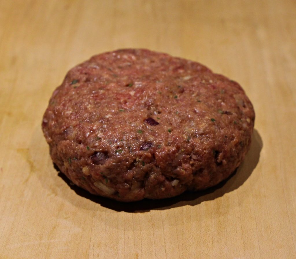 Raw beef burger patty