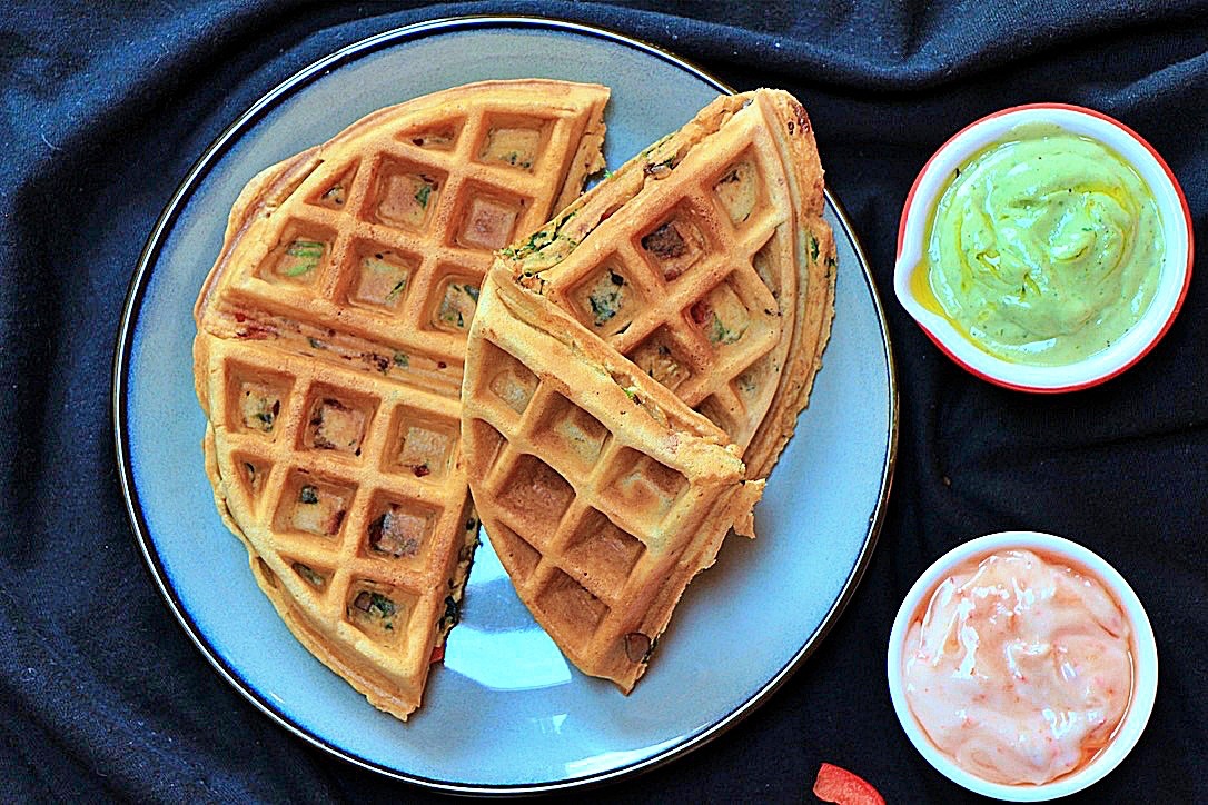 Savoury waffles plated with sauces