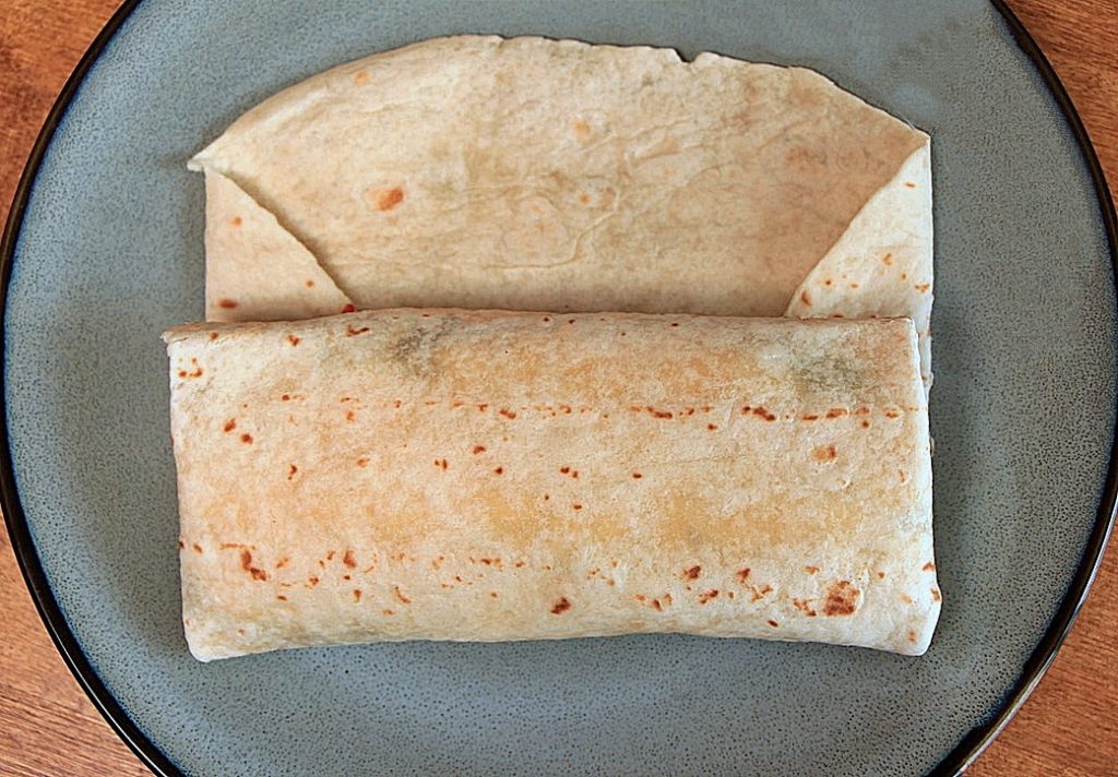 Grilled chicken wrap folded into a pillow