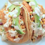 Fish taco with coleslaw and corn