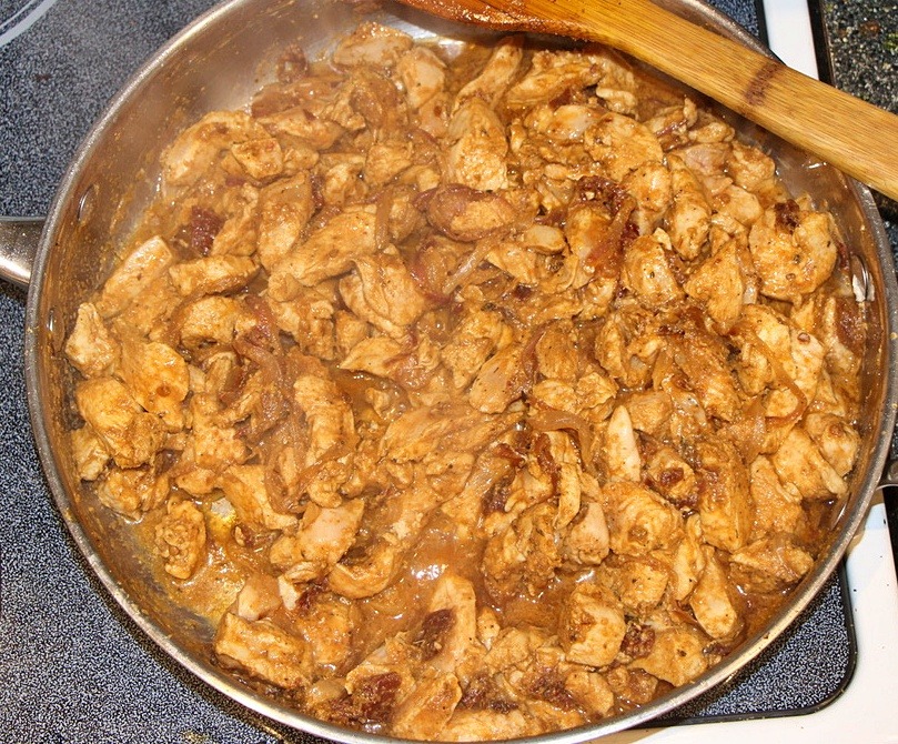 Chicken, spices and water in a pan