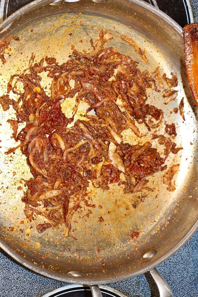 Onions and spices in a pan for pulled chicken