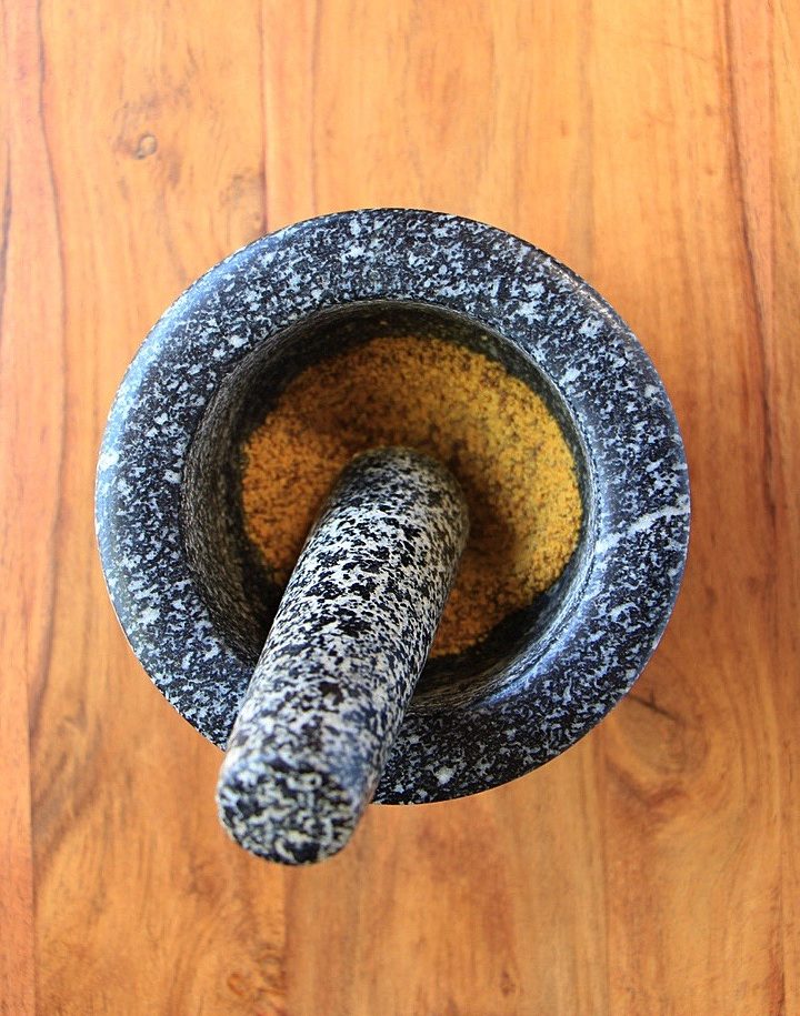 Spices in mortar and pestle for probiotic drink
