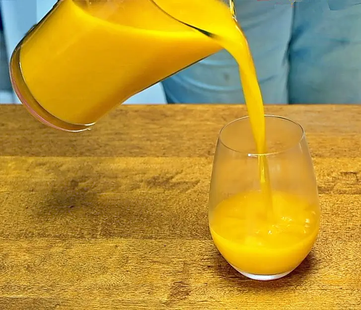 Pouring mango agua fresca