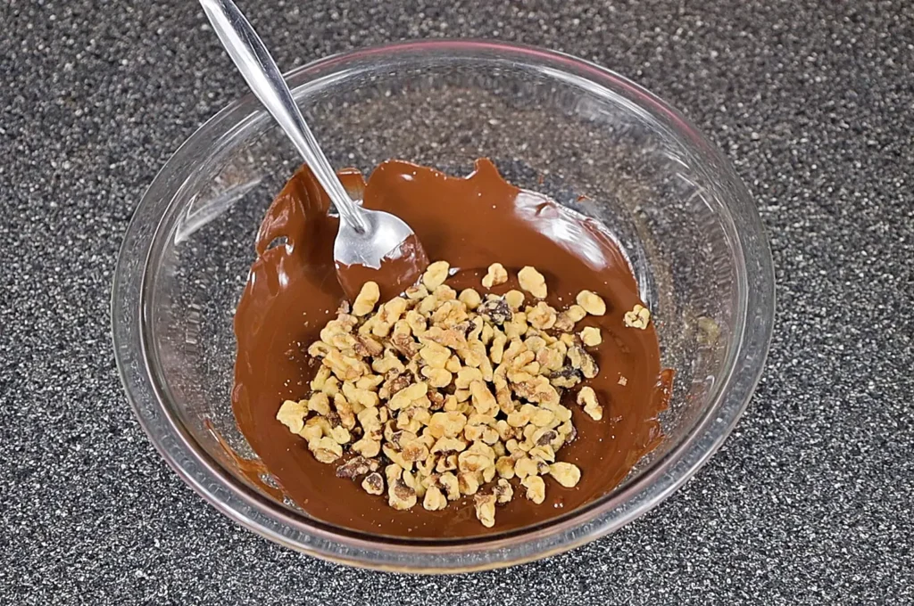 Adding the nuts to rocky road chocolate bark